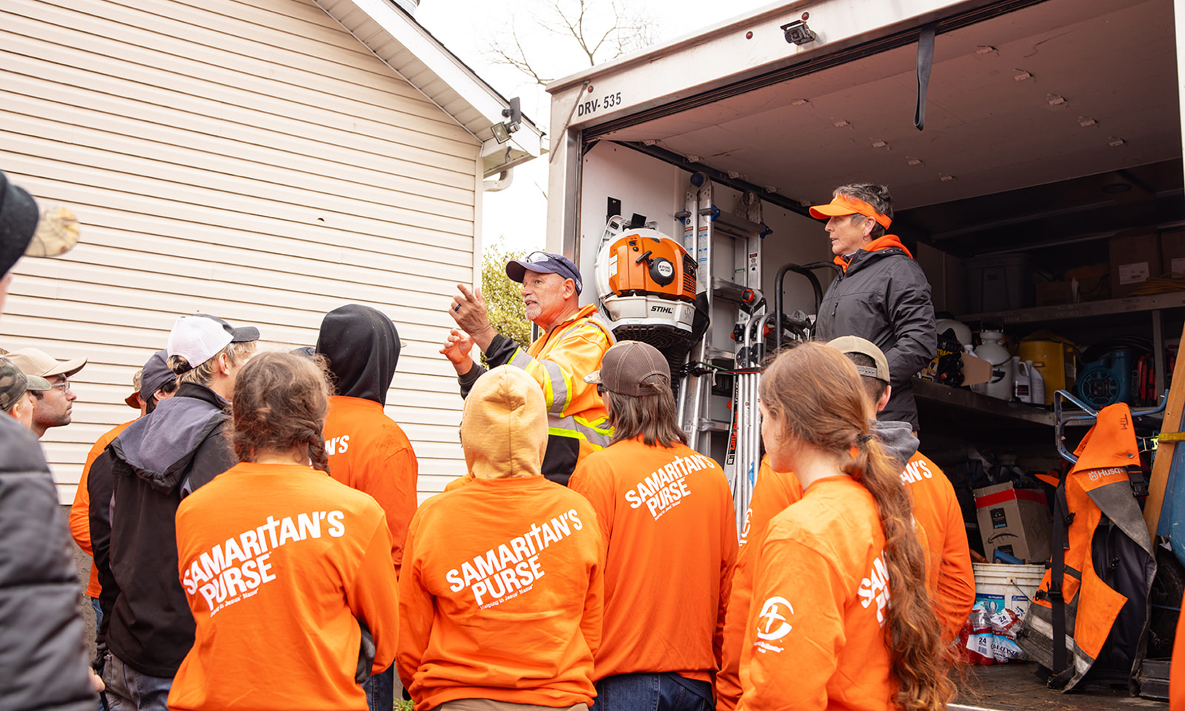 Teen volunteers getting instructions for hurricane cleanup